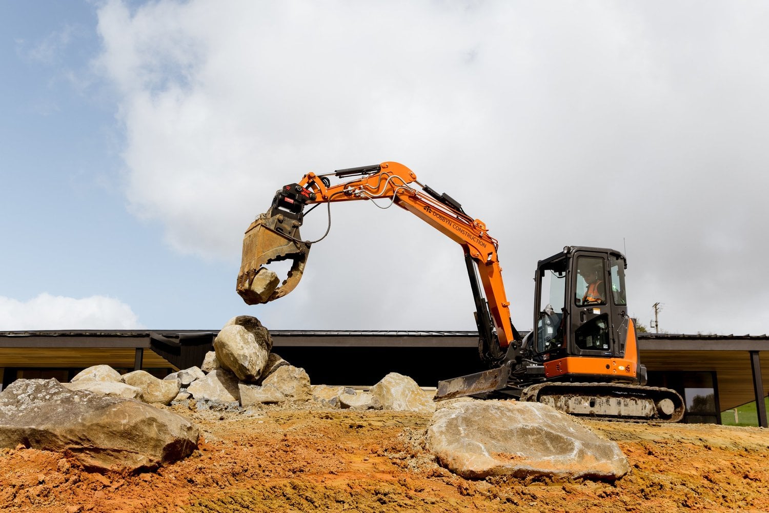 Dobbyn excavator placing rocks during site works