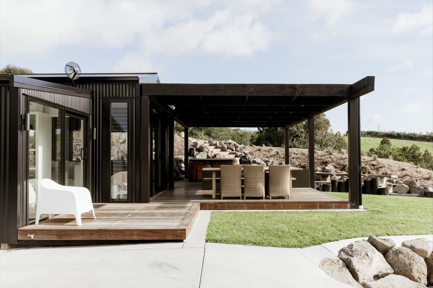 Dark-clad cabin with covered deck and outdoor seating